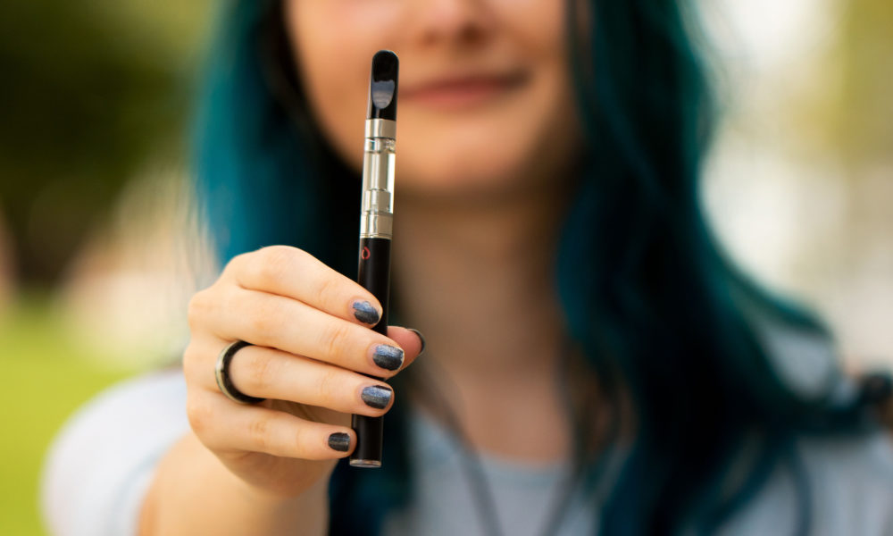 girl holding cbd vape pen 